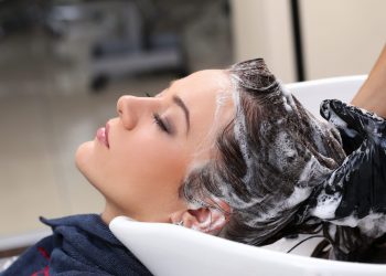 Hairdresser salon. Woman during hair wash
